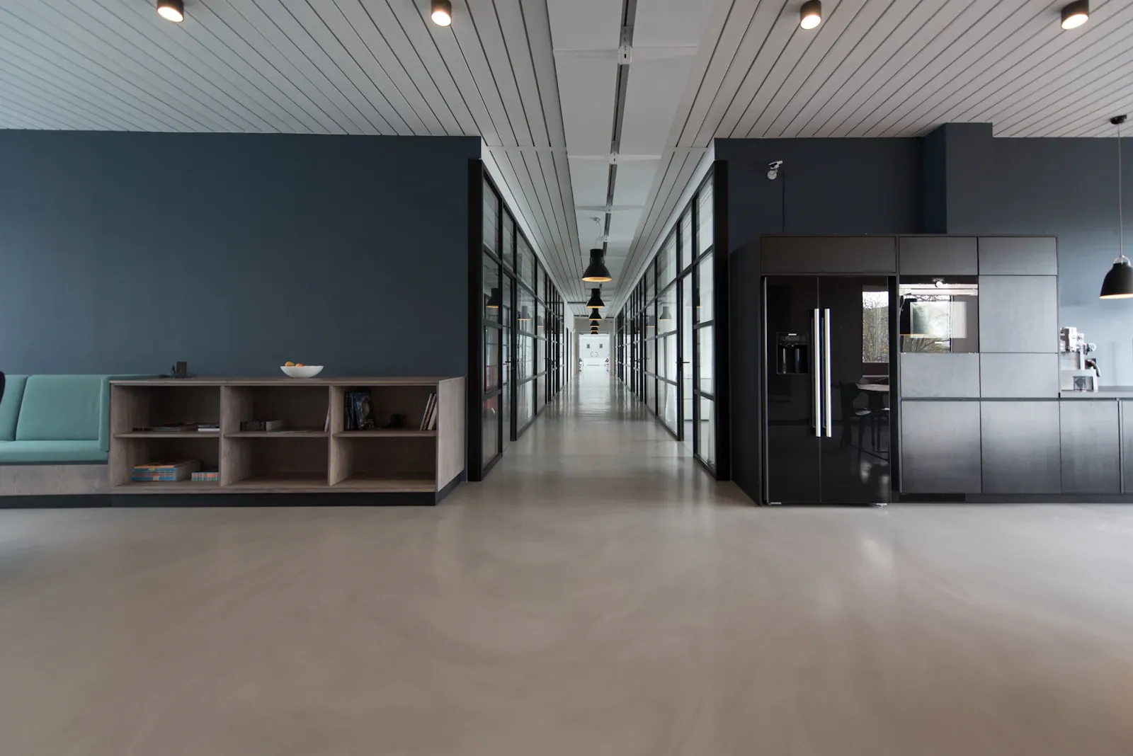North Quarter Offices, a long corridor with a slatted timber ceiling and polished concrete floor.